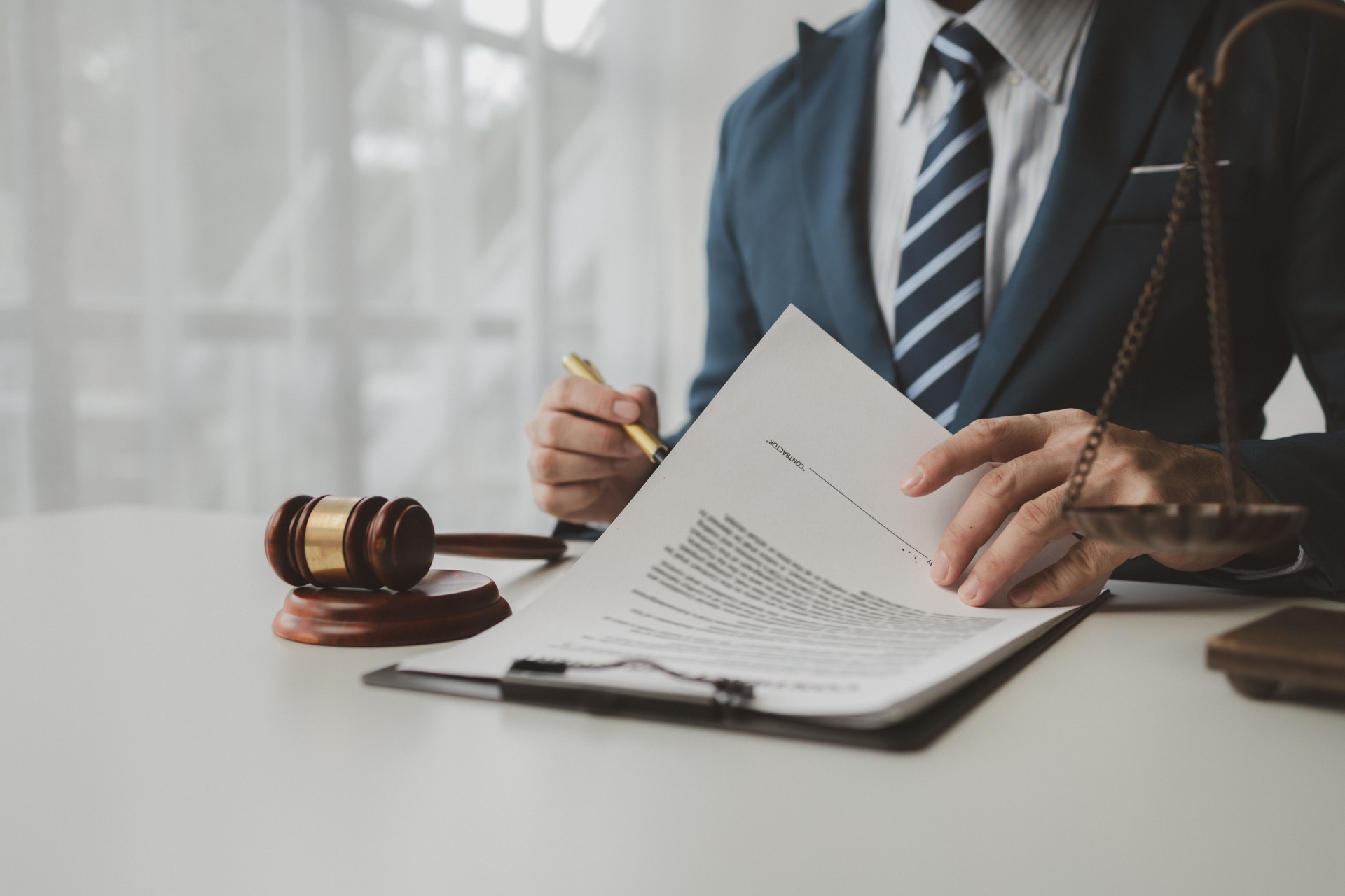 Lawyer is signing contract in the office, Diligent lawyer at work in a law firm, signing official document, Judge gavel with Justice lawyers, lawyer working on a documents, advice and justice concept.